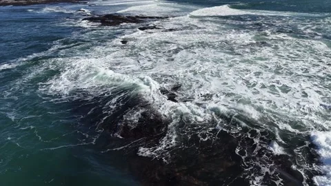 4K Slow Motion Waves Breaking Over Rocky Coast Stock Footage 333704380