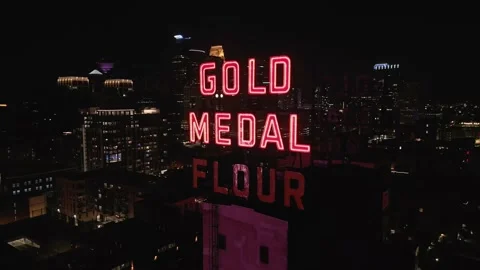 4K Slow Orbiting Aerial View Of Gold Medal Flour Sign In Minneapolis At Night Stock Footage 225649908