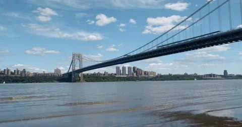 4K Slow pan right of George Washington Bridge Beach, New York City Stock Footage 202213587
