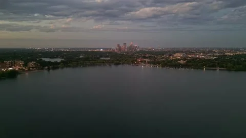 4K Slow Reverse Aerial View Of Minneapolis Skyline From Lake Calhoun At Sunset Video stock 220469815