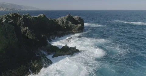 4k Slowmotion drone shot of powerful ocean waves crashing rocks in Tenerife Stock Footage 84047867