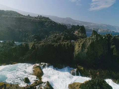 4k Slowmotion drone shot of powerful ocean waves crashing rocks in Tenerife Stock Footage 84064505
