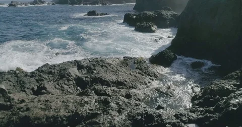 4k Slowmotion drone shot of powerful ocean waves crashing rocks in Tenerife Stock Footage 84075516