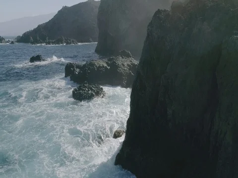 4k Slowmotion drone shot of powerful ocean waves crashing rocks in Tenerife Stock Footage 84169330