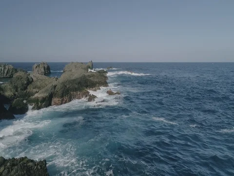 4k Slowmotion drone shot of powerful ocean waves crashing rocks in Tenerife Stock Footage 84169589