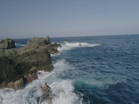 4k Slowmotion drone shot of powerful ocean waves crashing rocks in Tenerife Stock Footage 84169900