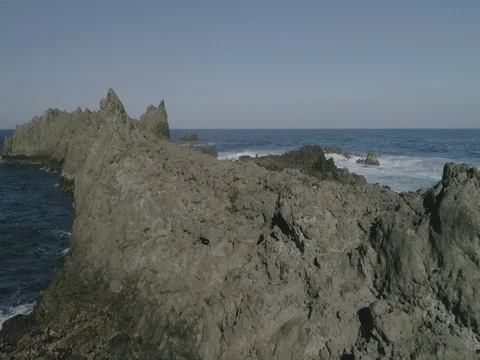 4k Slowmotion drone shot of powerful ocean waves crashing rocks in Tenerife Stock Footage 84171213