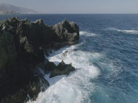 4k Slowmotion drone shot of powerful ocean waves crashing rocks in Tenerife Stock Footage 84190905