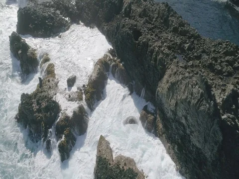4k Slowmotion drone shot of powerful ocean waves crashing rocks in Tenerife Stock Footage 84190951