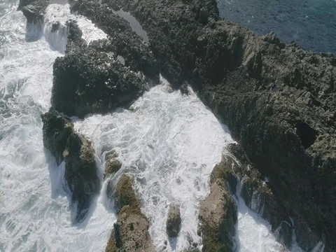 4k Slowmotion drone shot of powerful ocean waves crashing rocks in Tenerife Stock Footage 84190957