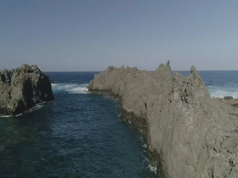 4k Slowmotion drone shot of powerful ocean waves crashing rocks in Tenerife Stock Footage 84191053