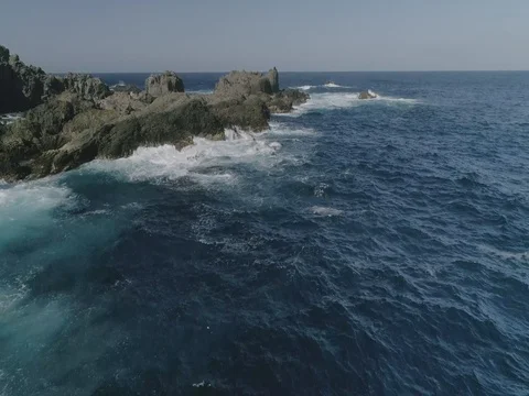 4k Slowmotion drone shot of powerful ocean waves crashing rocks in Tenerife Stock Footage 84191155