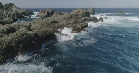 4k Slowmotion drone shot of powerful ocean waves crashing rocks in Tenerife Stock Footage 84191215