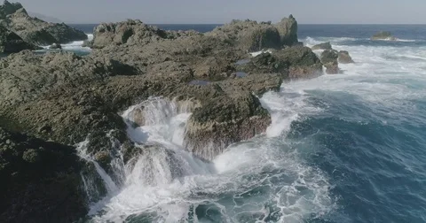 4k Slowmotion drone shot of powerful ocean waves crashing rocks in Tenerife Stock Footage 84191237