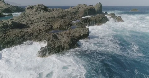 4k Slowmotion drone shot of powerful ocean waves crashing rocks in Tenerife Stock Footage 84191262