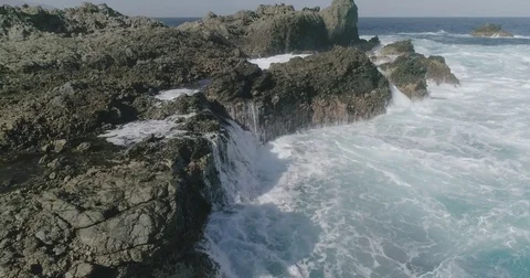 4k Slowmotion drone shot of powerful ocean waves crashing rocks in Tenerife Stock Footage 84191283