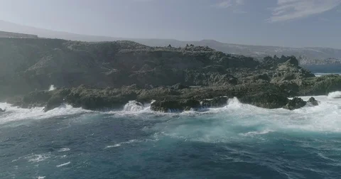 4k Slowmotion drone shot of powerful ocean waves crashing rocks in Tenerife Stock Footage 84191396