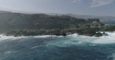 4k Slowmotion drone shot of powerful ocean waves crashing rocks in Tenerife Stock Footage 84191473