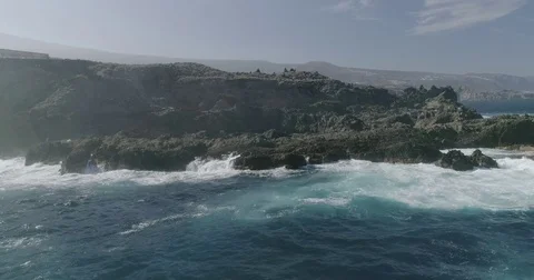 4k Slowmotion drone shot of powerful ocean waves crashing rocks in Tenerife Stock Footage 84191555