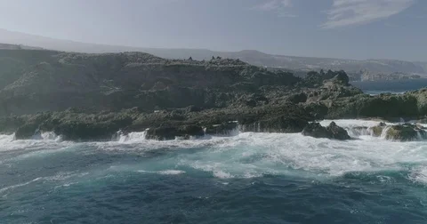4k Slowmotion drone shot of powerful ocean waves crashing rocks in Tenerife Stock Footage 84191717