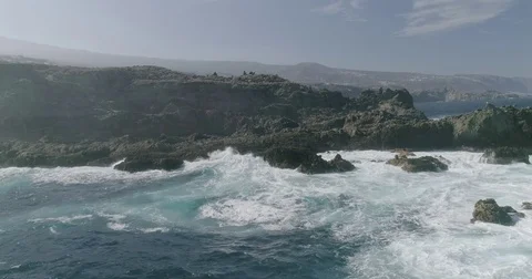 4k Slowmotion drone shot of powerful ocean waves crashing rocks in Tenerife Stock Footage 84191840