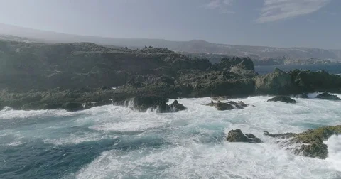 4k Slowmotion drone shot of powerful ocean waves crashing rocks in Tenerife Stock Footage 84191883