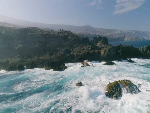 4k Slowmotion drone shot of powerful ocean waves crashing rocks in Tenerife Stock Footage 84191932