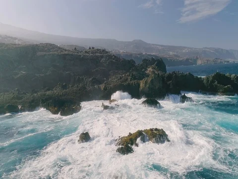 4k Slowmotion drone shot of powerful ocean waves crashing rocks in Tenerife Stock Footage 84192032