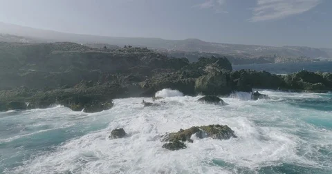 4k Slowmotion drone shot of powerful ocean waves crashing rocks in Tenerife Stock Footage 84192084