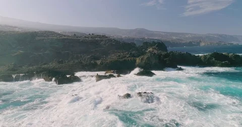 4k Slowmotion drone shot of powerful ocean waves crashing rocks in Tenerife Stock Footage 84192093