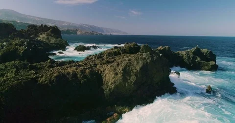 4k Slowmotion drone shot of powerful ocean waves crashing rocks in Tenerife Stock Footage 84192489