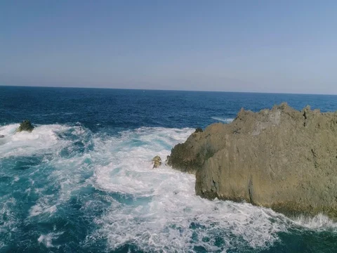4k Slowmotion drone shot of powerful ocean waves crashing rocks in Tenerife Stock Footage 84194154