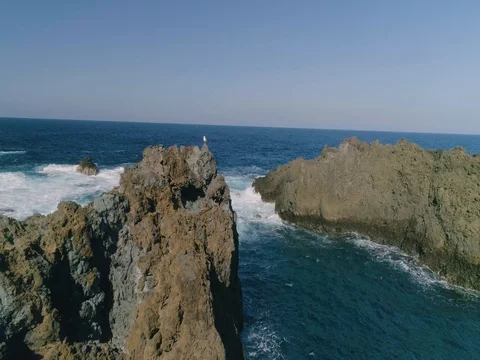 4k Slowmotion drone shot of powerful ocean waves crashing rocks in Tenerife Stock Footage 84194155