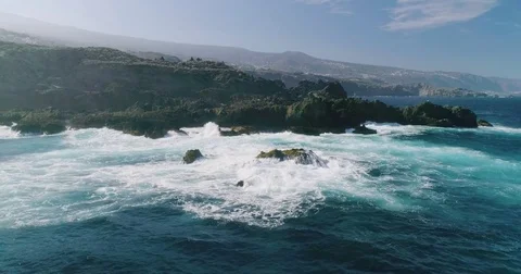 4k Slowmotion drone shot of powerful ocean waves crashing rocks in Tenerife Stock Footage 84194560