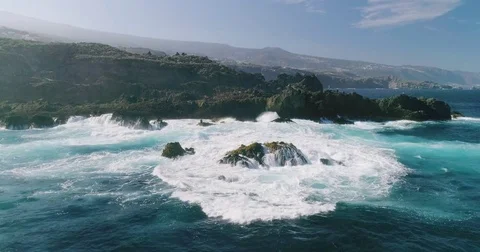 4k Slowmotion drone shot of powerful ocean waves crashing rocks in Tenerife Stock Footage 84194644