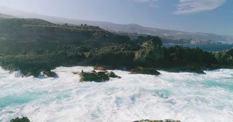 4k Slowmotion drone shot of powerful ocean waves crashing rocks in Tenerife Stock Footage 84194682