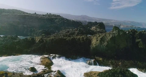 4k Slowmotion drone shot of powerful ocean waves crashing rocks in Tenerife Stock Footage 84194716