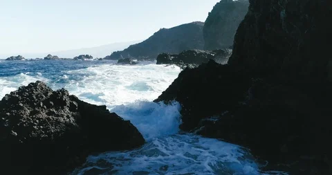 4k Slowmotion drone shot of powerful ocean waves crashing rocks in Tenerife Stock Footage 90272313