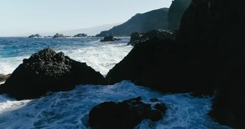 4k Slowmotion drone shot of powerful ocean waves crashing rocks in Tenerife Stock Footage 90272421