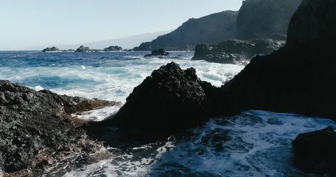 4k Slowmotion drone shot of powerful ocean waves crashing rocks in Tenerife Stock Footage 90272436