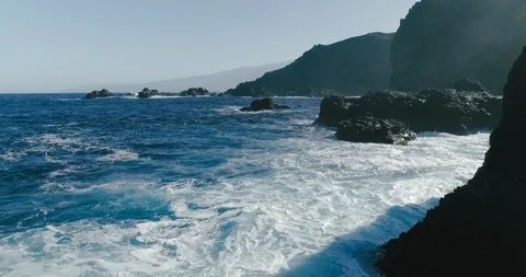 4k Slowmotion drone shot of powerful ocean waves crashing rocks in California Stock Footage 90272554