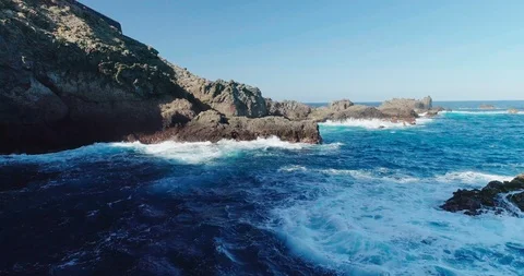 4k Slowmotion drone shot of powerful ocean waves crashing rocks in Tenerife Stock Footage 90272847