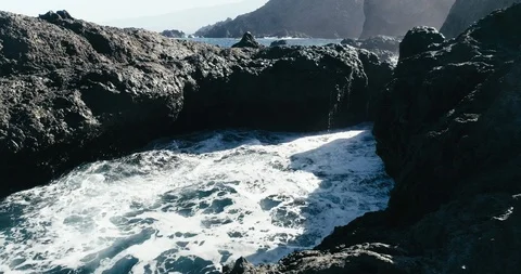 4k Slowmotion drone shot of powerful ocean waves crashing rocks in Tenerife Stock Footage 90272924