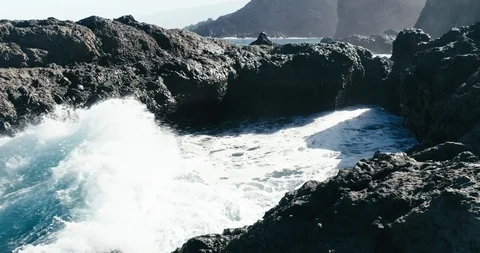 4k Slowmotion drone shot of powerful ocean waves crashing rocks in Tenerife Stock Footage 90272925