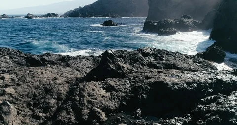 4k Slowmotion drone shot of powerful ocean waves crashing rocks in Tenerife Stock Footage 90272942
