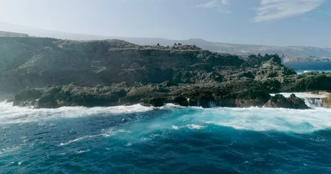 4k Slowmotion drone shot of powerful ocean waves crashing rocks in Tenerife Stock Footage 90282450