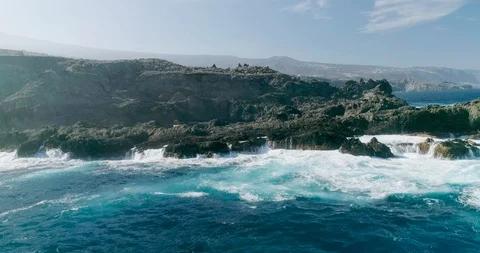 4k Slowmotion drone shot of powerful ocean waves crashing rocks in Tenerife Stock Footage 90282457
