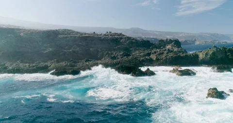 4k Slowmotion drone shot of powerful ocean waves crashing rocks in Tenerife Stock Footage 90283112
