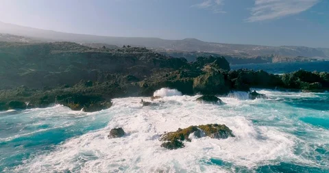 4k Slowmotion drone shot of powerful ocean waves crashing rocks in Tenerife Stock Footage 90283674