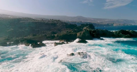 4k Slowmotion drone shot of powerful ocean waves crashing rocks in Tenerife Stock Footage 90283779